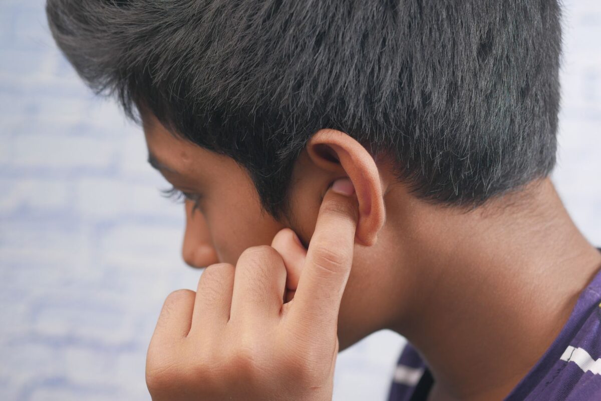 A side view of a person's ear and head