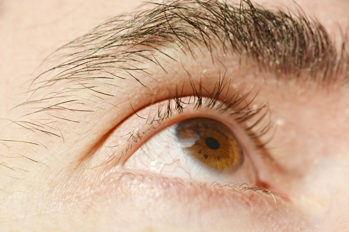 A close-up of a human eye with a brown iris