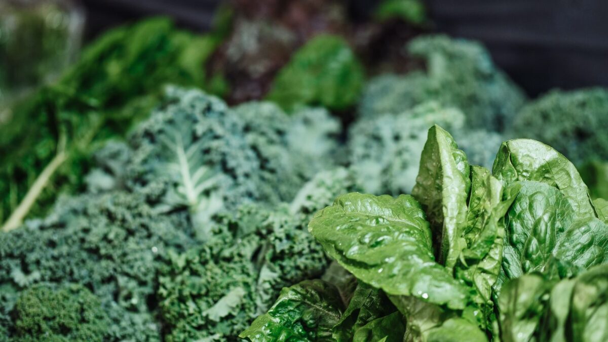 Fresh leafy greens including kale and spinach, natural sources of lutein and zeaxanthin